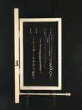 Inside view of an Earring Holder & Jewelry Organizer Cabinet showing necklace and bracelets on the intereior hooks - by Earring Holder Gallery  