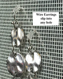 wire earrings hanging in an earring holder